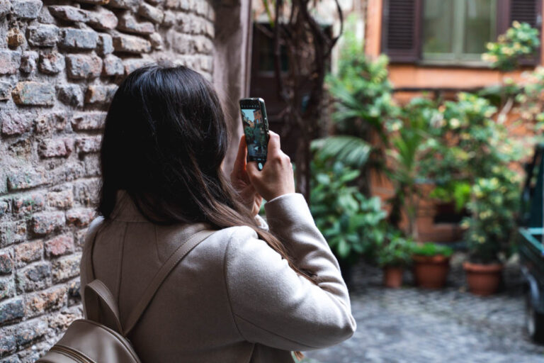 Rome Vicolo degli Acetari and a young woman photographing it