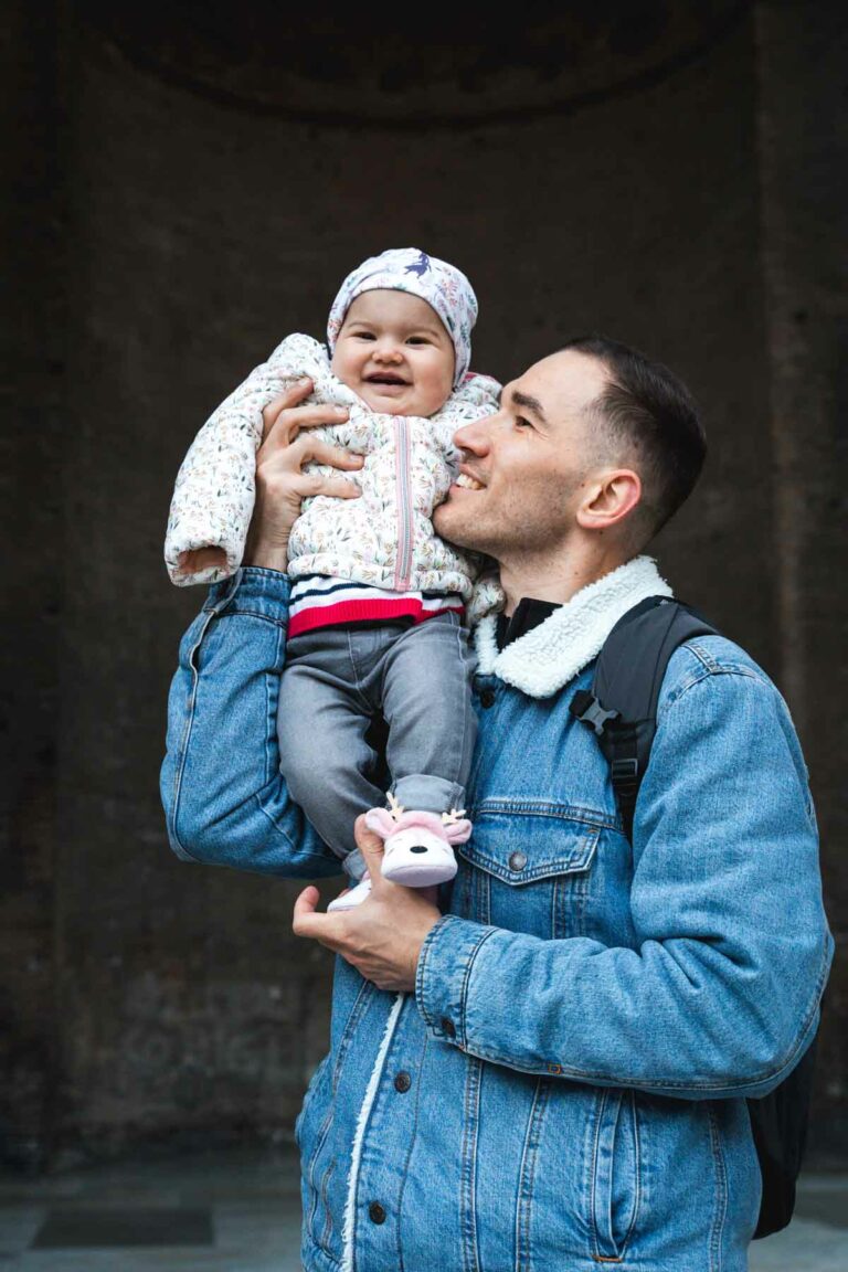 Young man holding his baby around the Pantheon